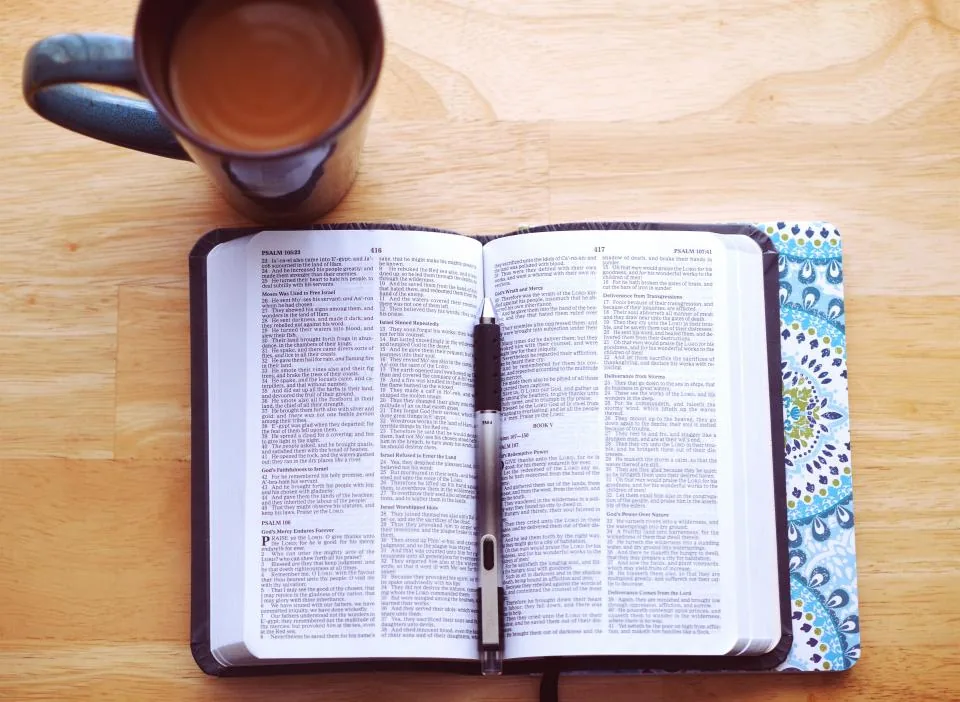 Open Bible with a pen and a cup of coffee